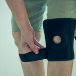 old Asian women to knee injury and use knee support brace on leg